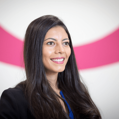 Monica stood in front of the Ocorian pink O